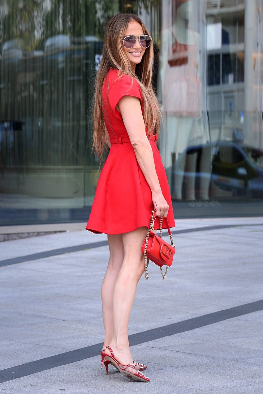 Jennifer Lopez wearing a Valentino red mini dress, kitten heels, and bag in Warsaw, Poland