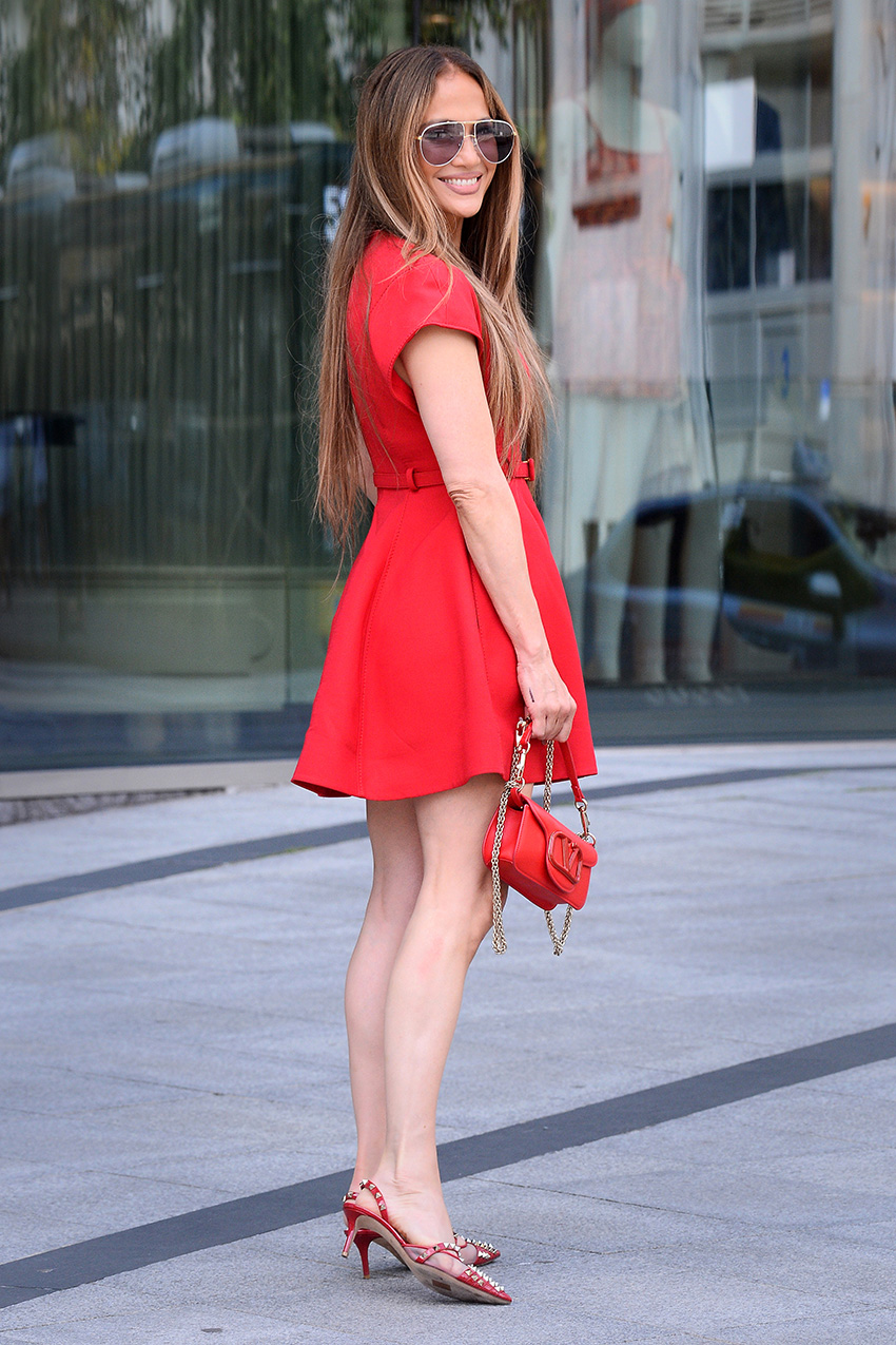 Jennifer Lopez wearing a Valentino red mini dress, kitten heels, and bag in Warsaw, Poland