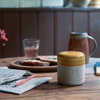 dining table with coffee mug and loaf candles