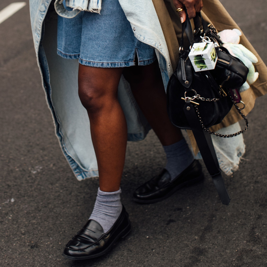 fashion week attendee wearing loafers, grey socks, and denim shorts