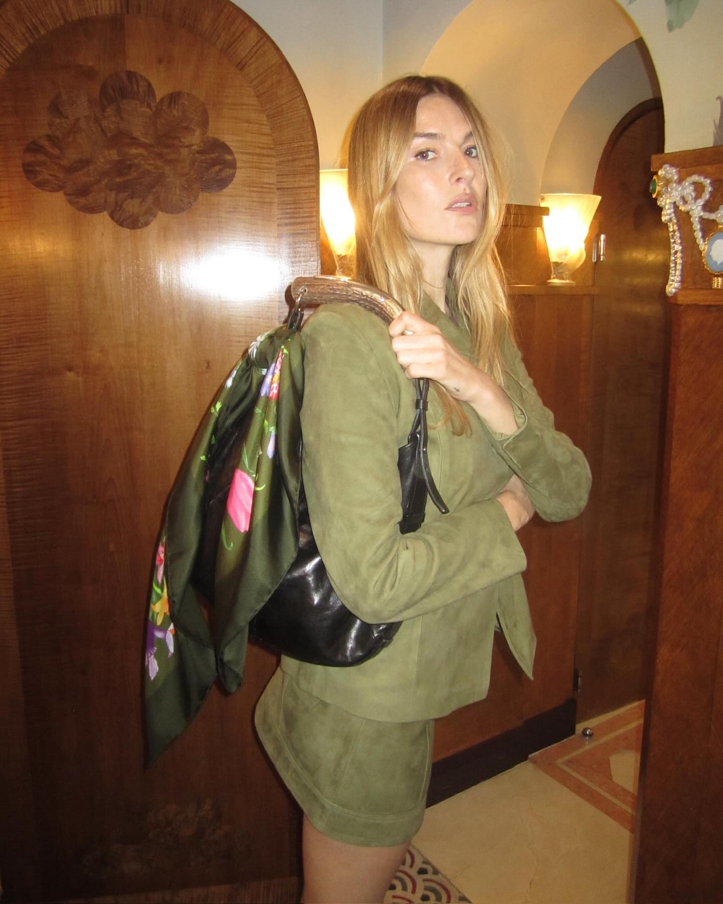 An image of @camillecharriere with a scarf bag charm, one of the most stylish ways to wear a scarf in 2025.