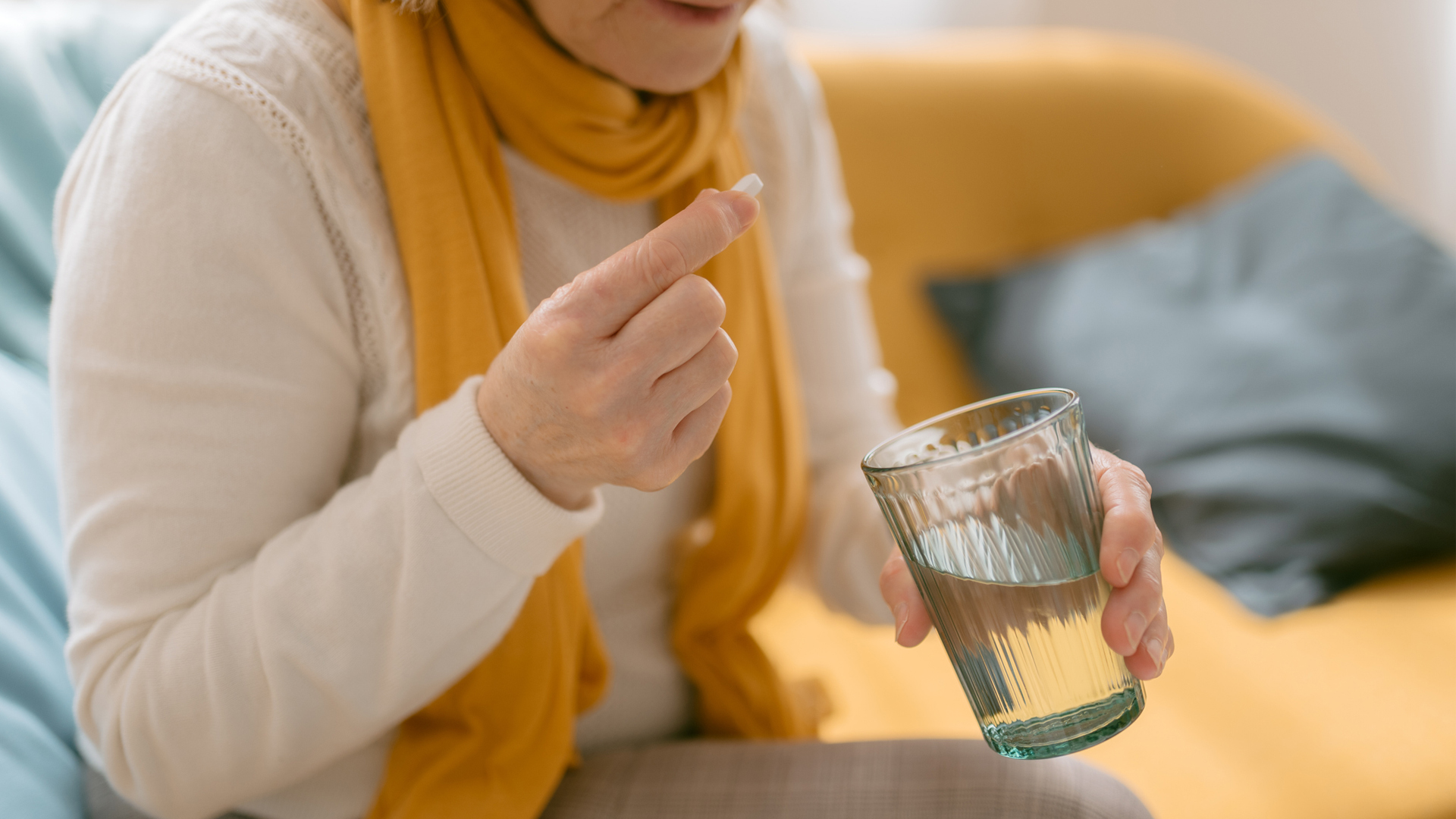 woman taking a vitamin D supplement