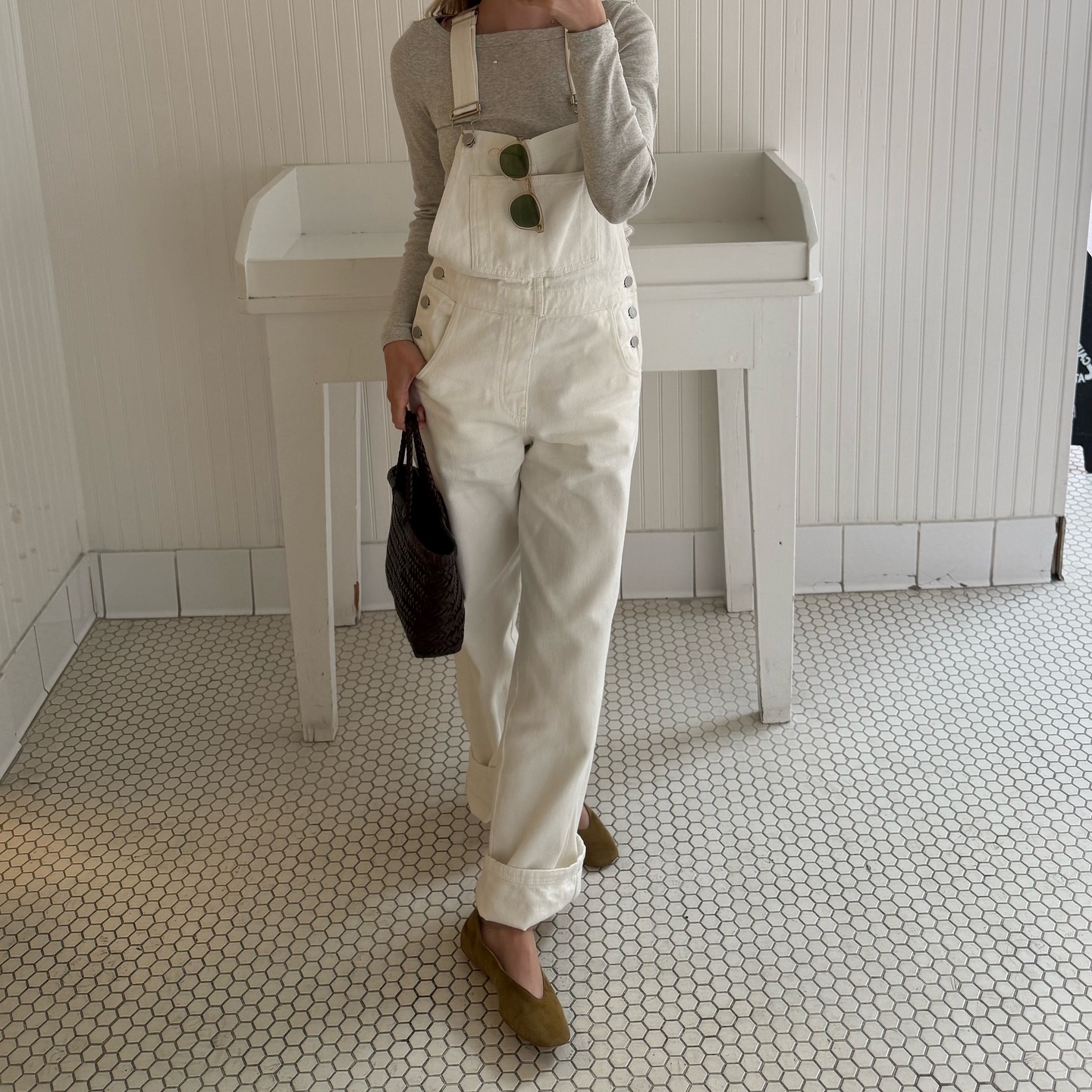 An image of @caitlinburnhamm wearing white overalls, one of the biggest denim trends of 2026.