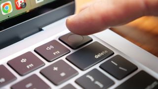 Close up of the fingerprint sensor on the Apple MacBook Air 13-inch M4 with a finger hovering above it.