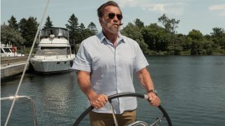 Arnold Schwarzenegger smoking a cigar while driving a boat in FUBAR.