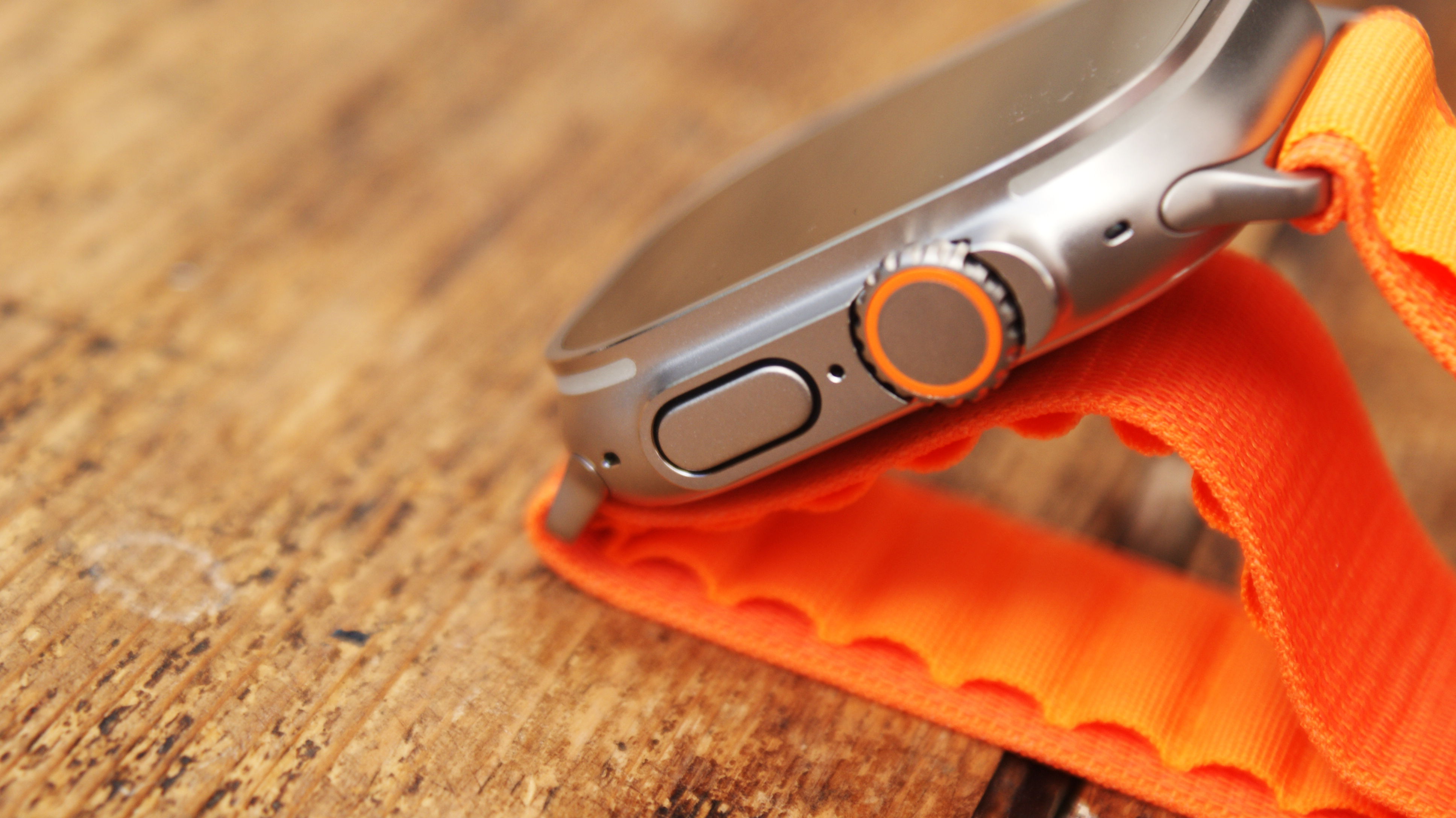 Apple Watch Ultra in use on wrist and on table