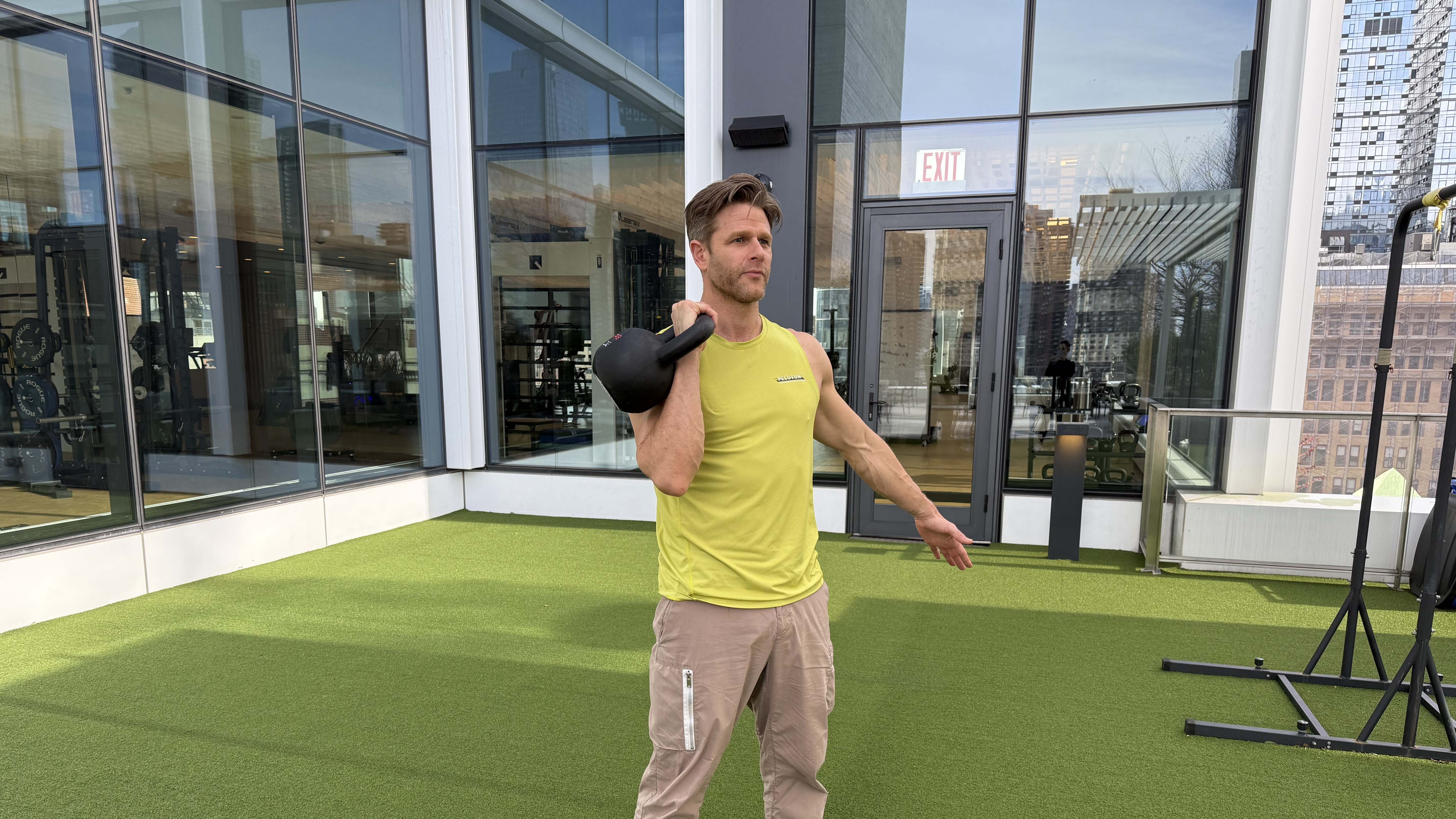 a photo of Peloton trainer Andy Speer doing a kettlebell single-arm racked lunge