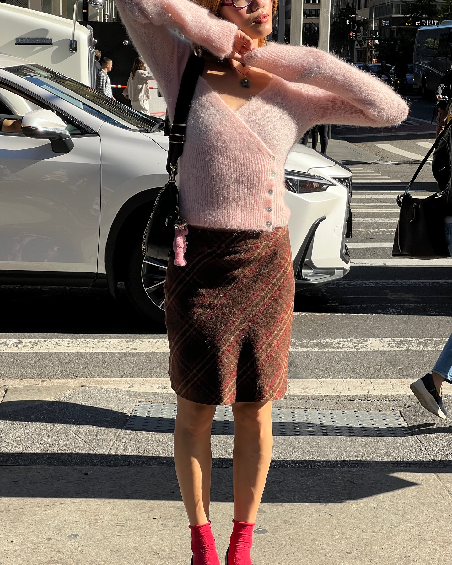 Influencer @vivianyrl wears a wrap cardigan with a wool pencil skirt and red socks.