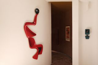 red sculpture on wall