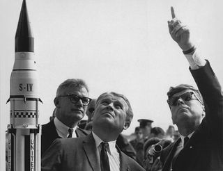 NASA Deputy Administrator Robert Seamans, rocket engineer Wernher von Braun and President John F. Kennedy discuss the Saturn rockets that went on to power the Apollo program.