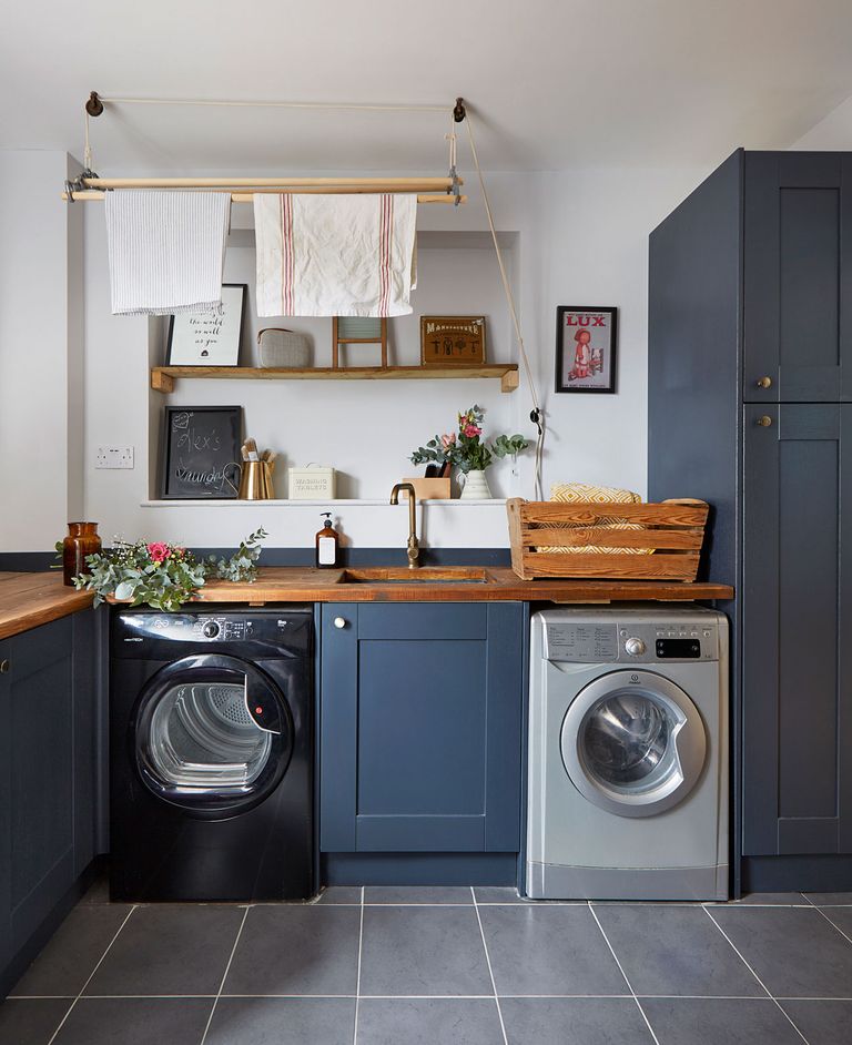 Quietest washing machine in a kitchen with a tumble dryer and blue cabinet doors