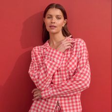 Woman wearing red gingham pyjamas on red background