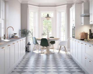 galley kitchen with dining table with white cabinets, black and white floor and in built appliances