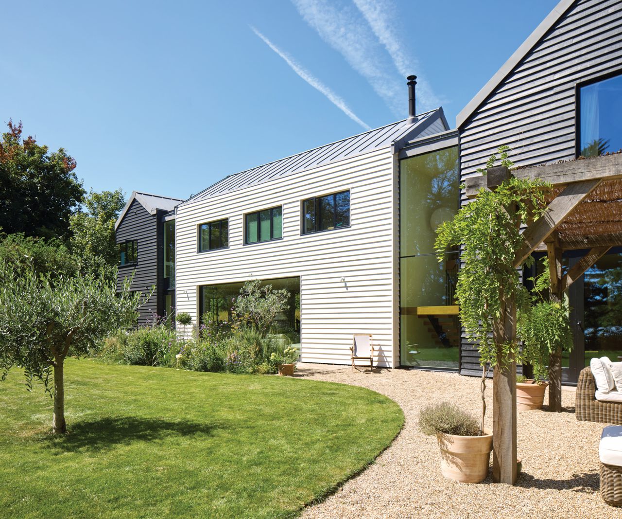 Exterior of house with curved gravel and lawn in front