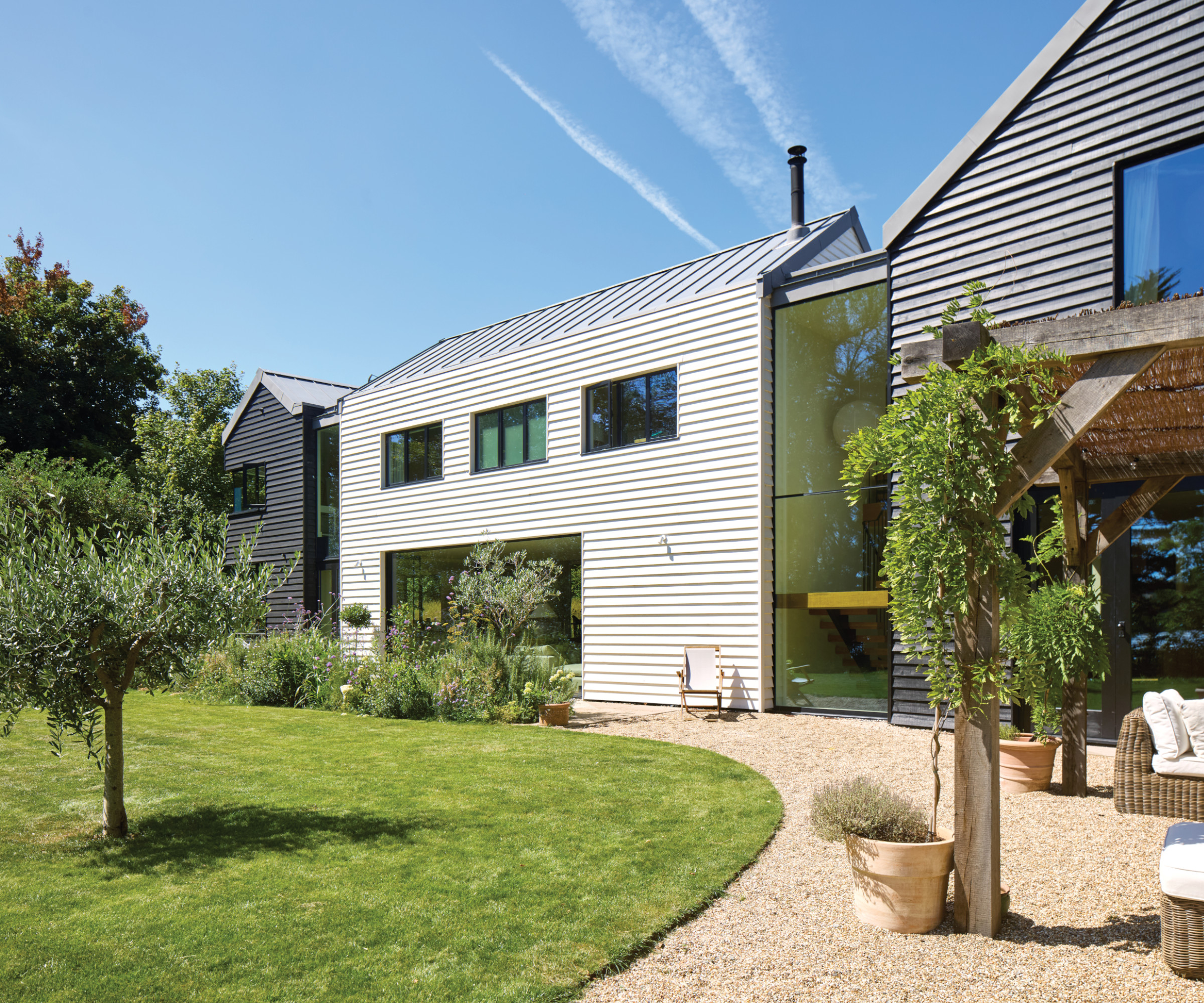 Exterior of house with curved gravel and lawn in front