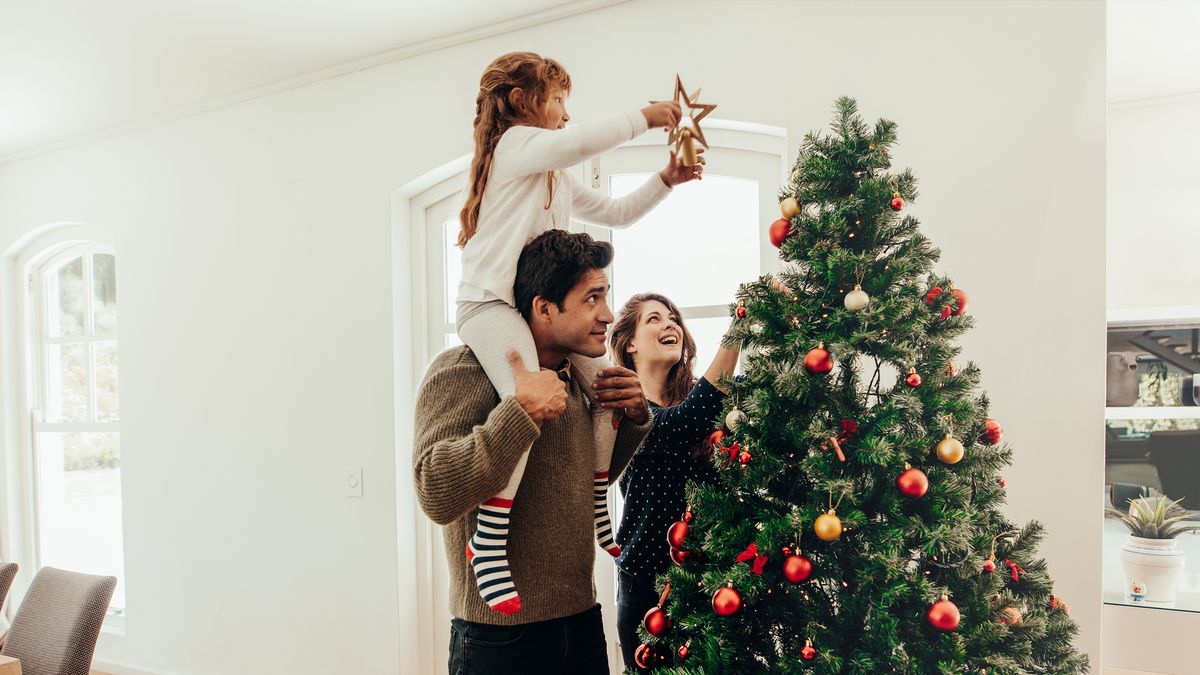 A family standing in front of a Christmas tree