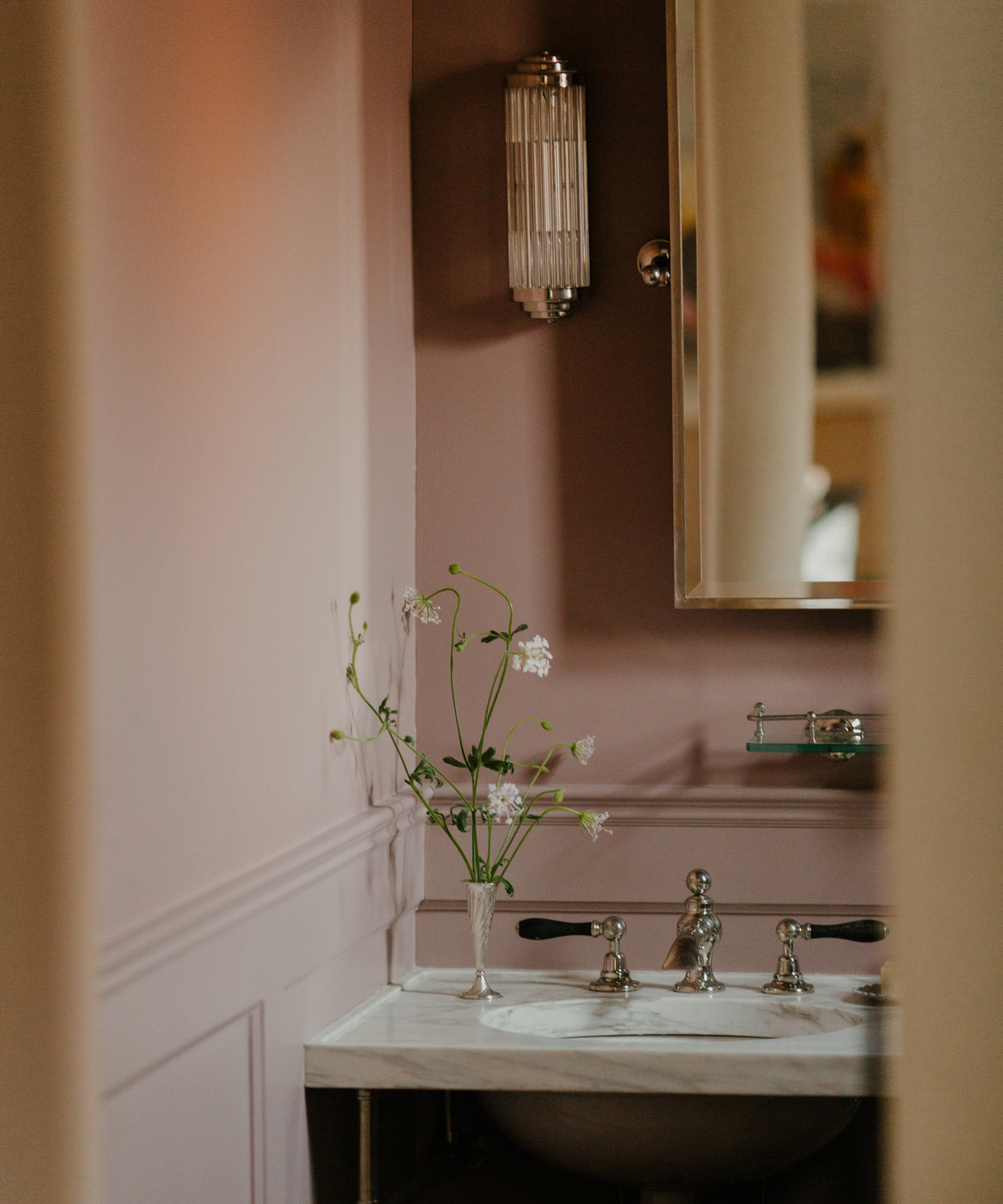 powder room with pale pink wall and marble vanity