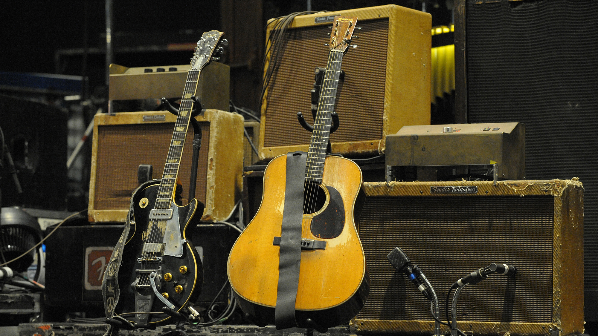 Neil Young's Gibson Les Paul and Martin acoustic guitars in front of vintage tweed Fender amplifiers on stage at Olympiahalle on June 17, 2009 in Munich, Germany.
