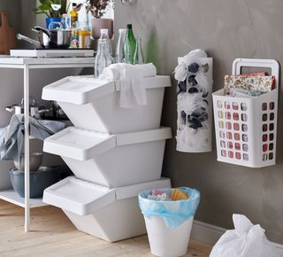 An organized space with a plastic bag dispenser on the wall