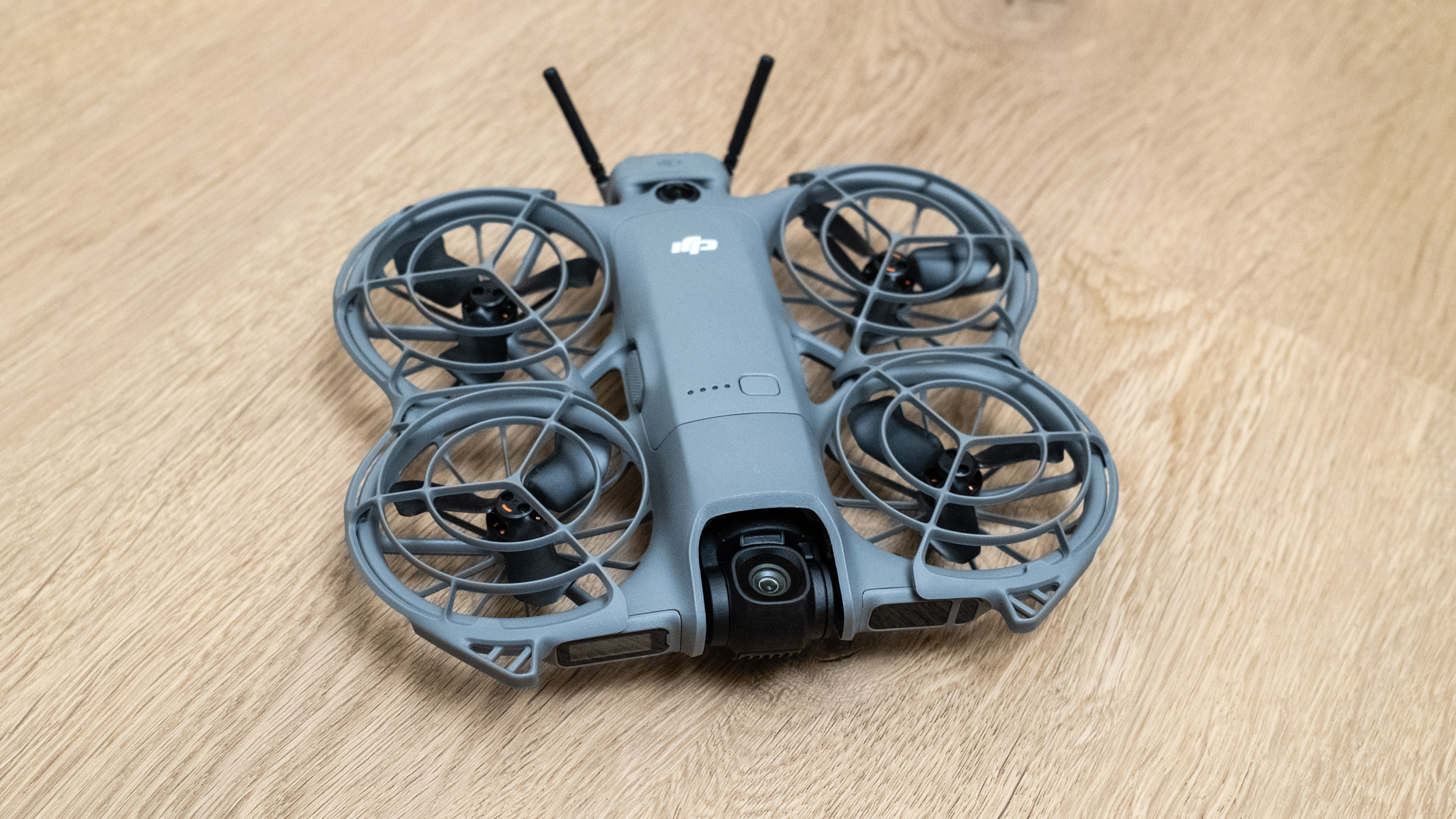 DJI Neo 2 front view on a wooden floor