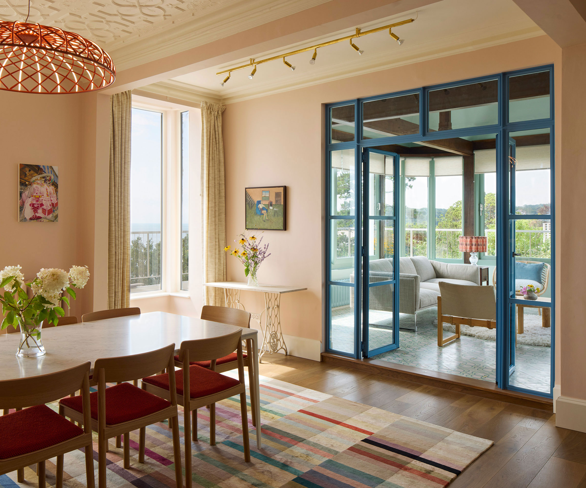 dining room with oak framed conservatory leading off through blue painted internal doors