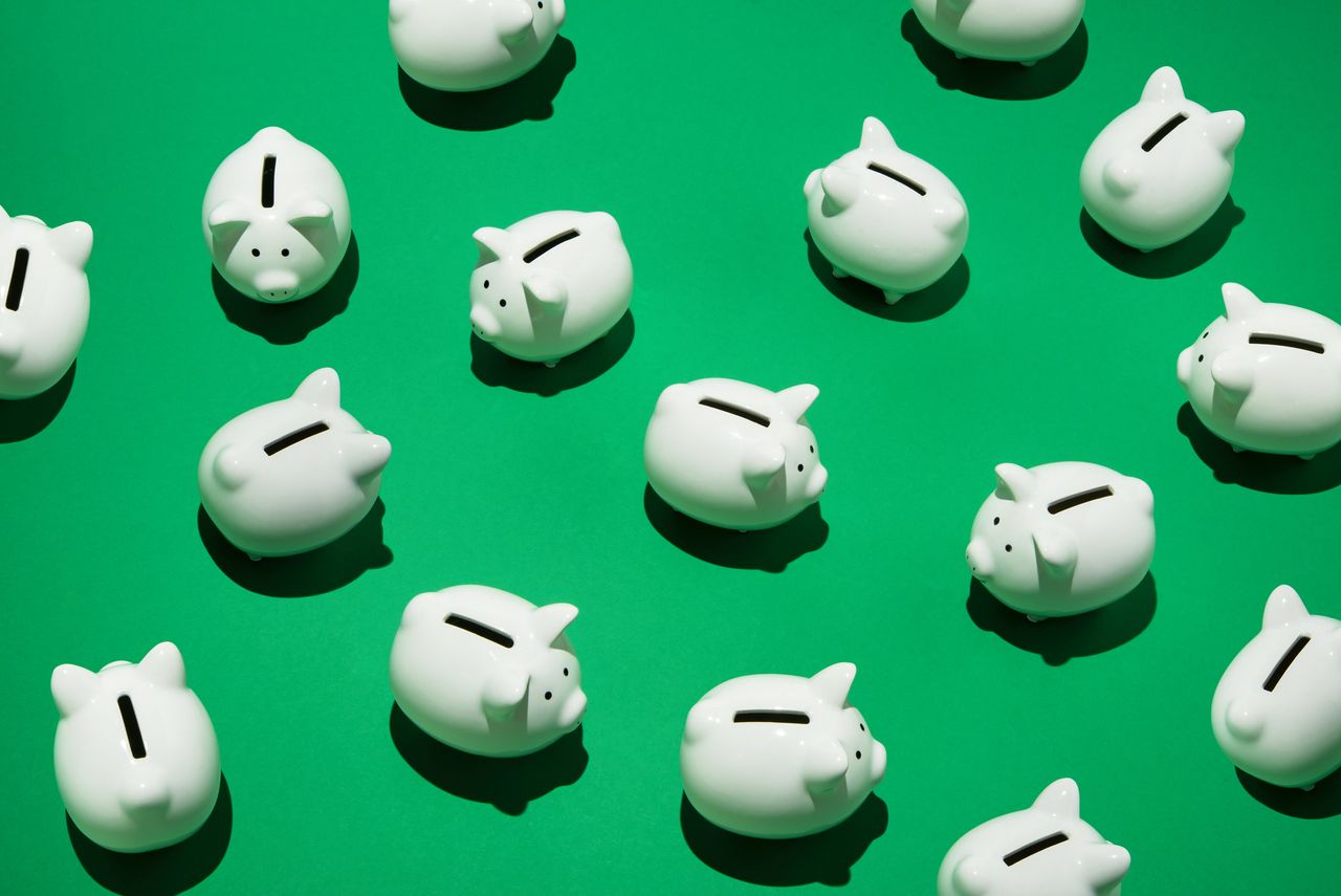 Piggy banks on green background