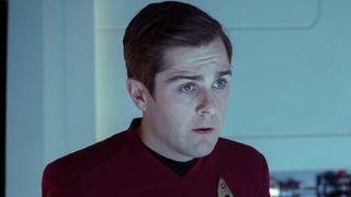 Scotty looking unsure while he's behind the transporter. 