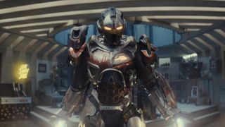 Riri Williams levitating in her armored suit in Joe's underground bunker in Ironheart