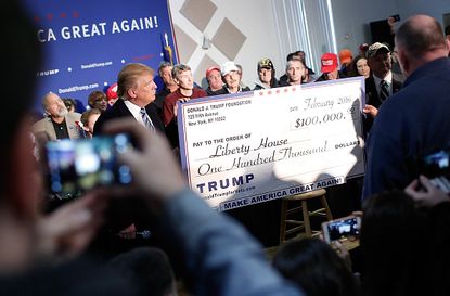 Donald Trump with a $100,000 check.