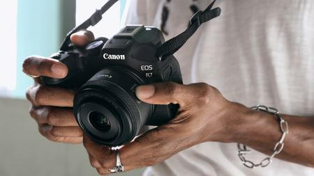 person holding EOS canon camera