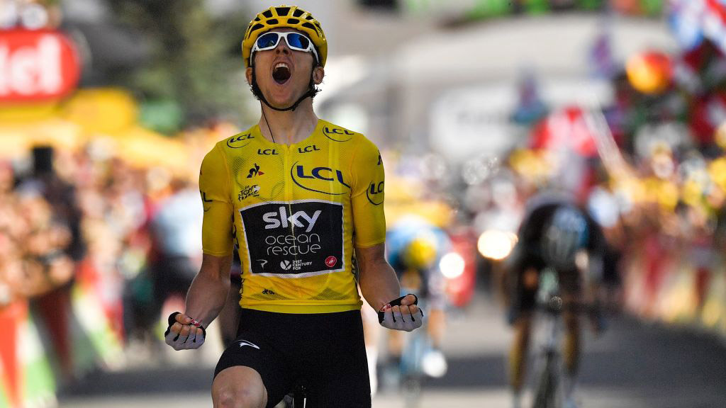 TOPSHOT - Great Britain&#039;s Geraint Thomas, wearing the overall leader&#039;s yellow jersey, celebrates as he crosses the finish line to win the twelfth stage of the 105th edition of the Tour de France cycling race, between Bourg-Saint-Maurice - Les Arcs and l&#039;Alpe d&#039;Huez, on July 19, 2018. (Photo by Marco BERTORELLO / AFP) (Photo credit should read MARCO BERTORELLO/AFP via Getty Images)