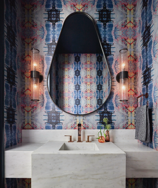 Bright blue patterned wallpaper used in a Powder Room