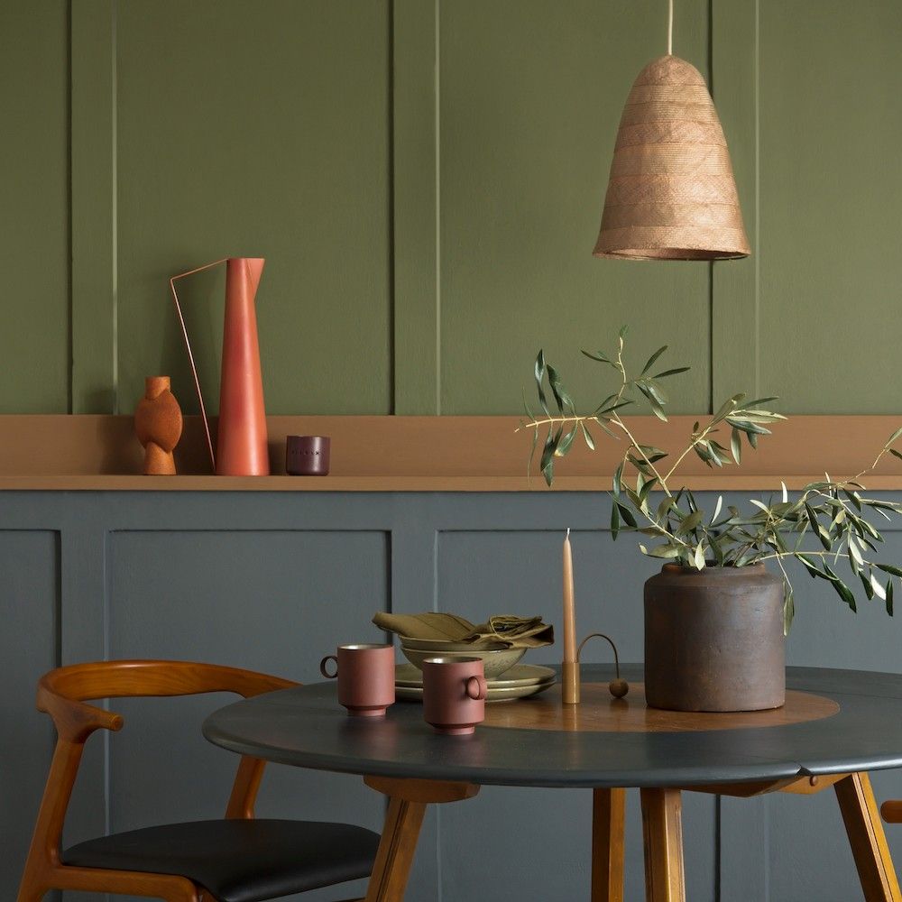 room with potted plant tea cups and wooden chair