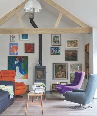 White living room with colorful furniture, gallery wall and exposed wooden beams