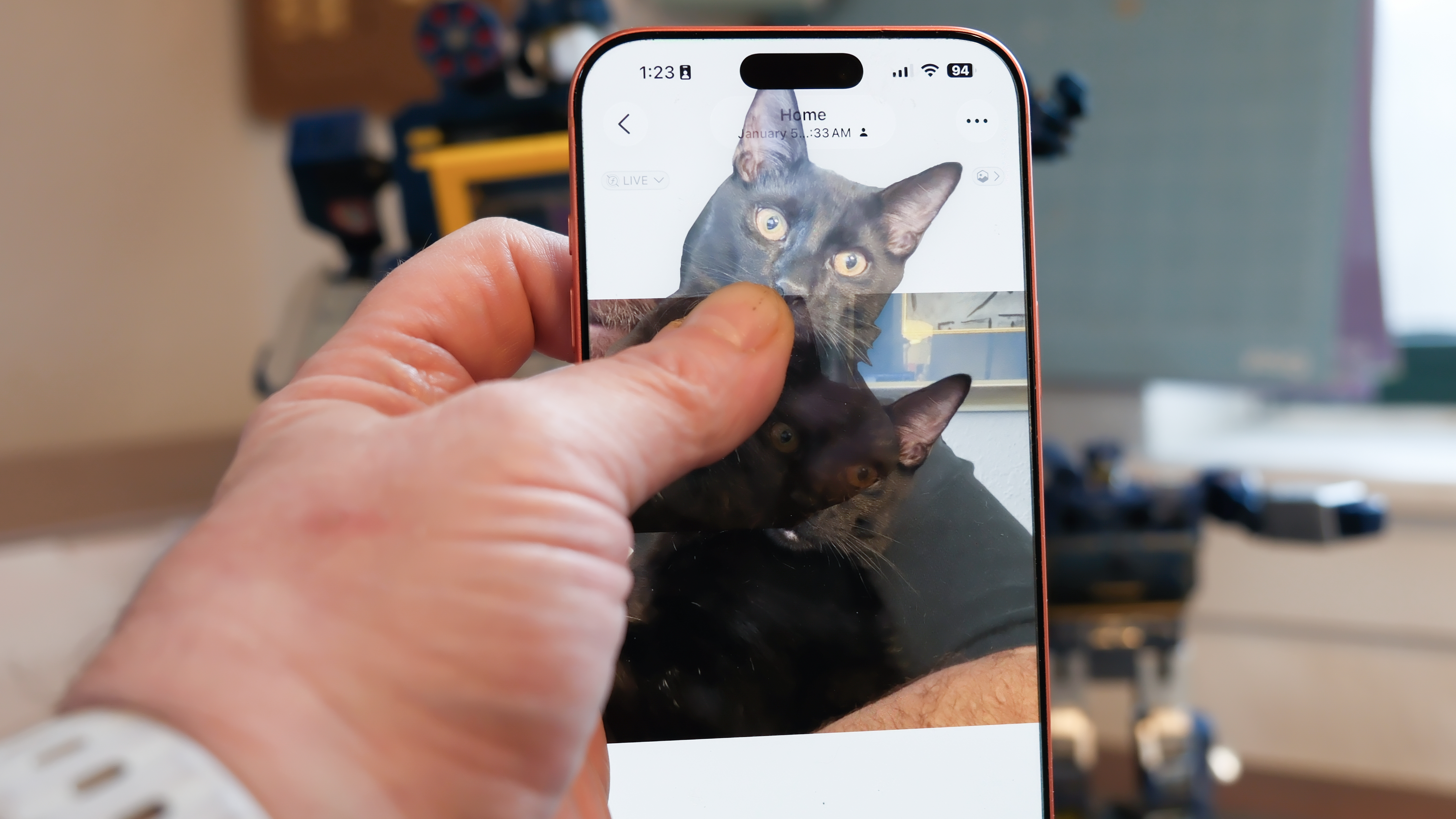 Apple iPhone 16 Pro Max in orange showing various Apple Messages features including sending check-ins, Apple Cash, and doodles