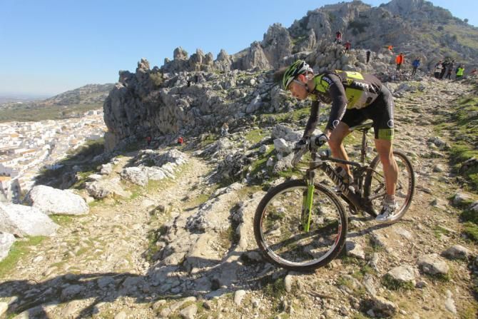 A rider negotiates a tight, rocky switchback.