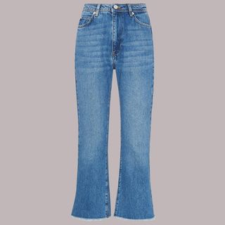 cut out image of a kick flare jeans in mid blue wash