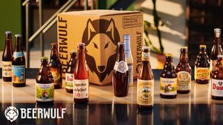 A selection of beers and a Beerwulf-branded box sitting on a table with the Beerwulf logo in the bottom left corner