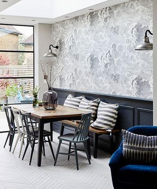 open plan kitchen-dining srea with feature wallpaper and banquette seating