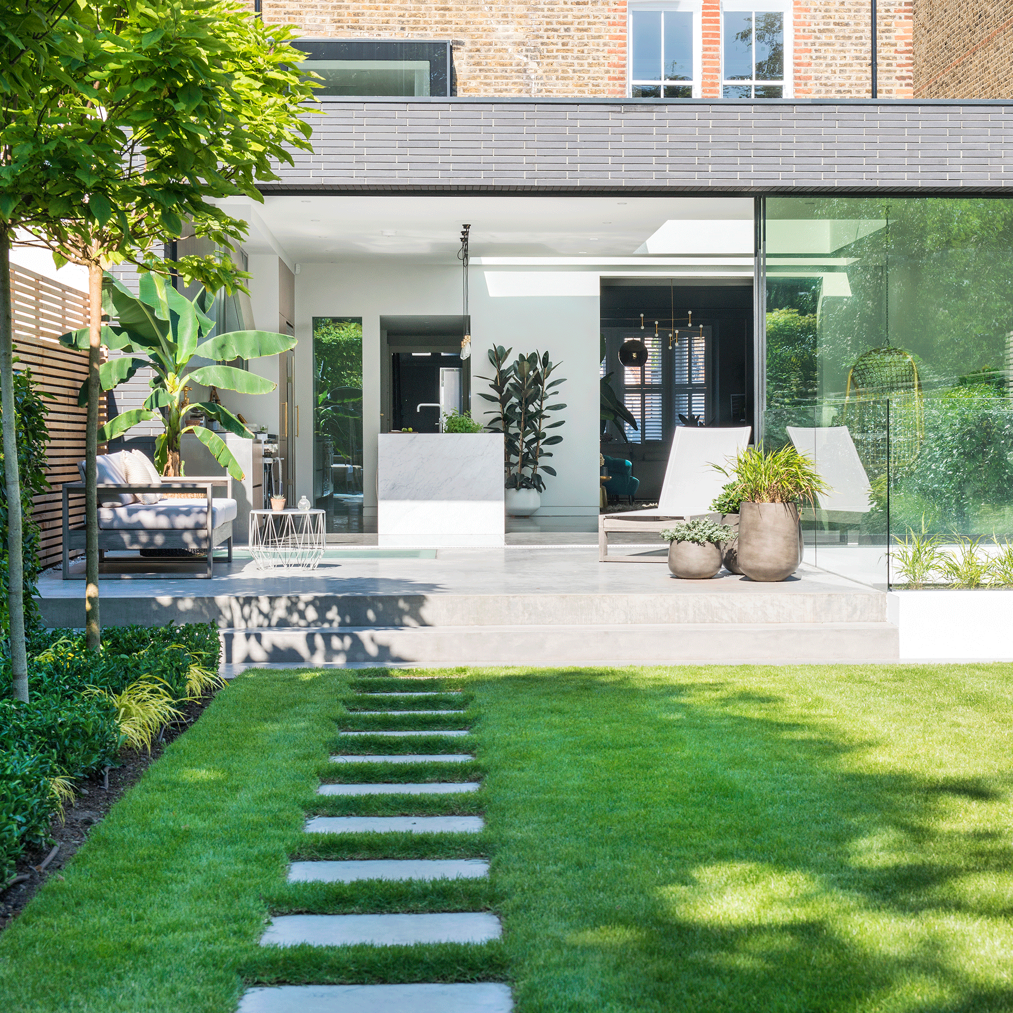 Green lawn with white paving slabs showing how to plan a garden