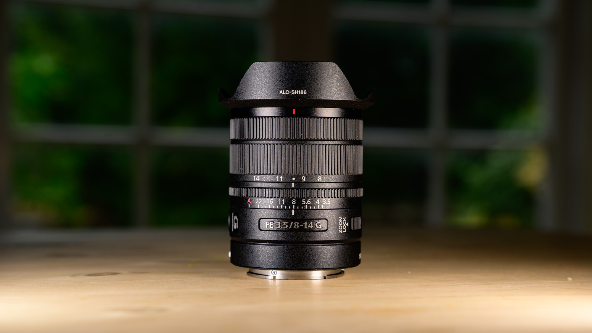 Sony FE 8-14mm F3.5 G fisheye lens on a wooden table