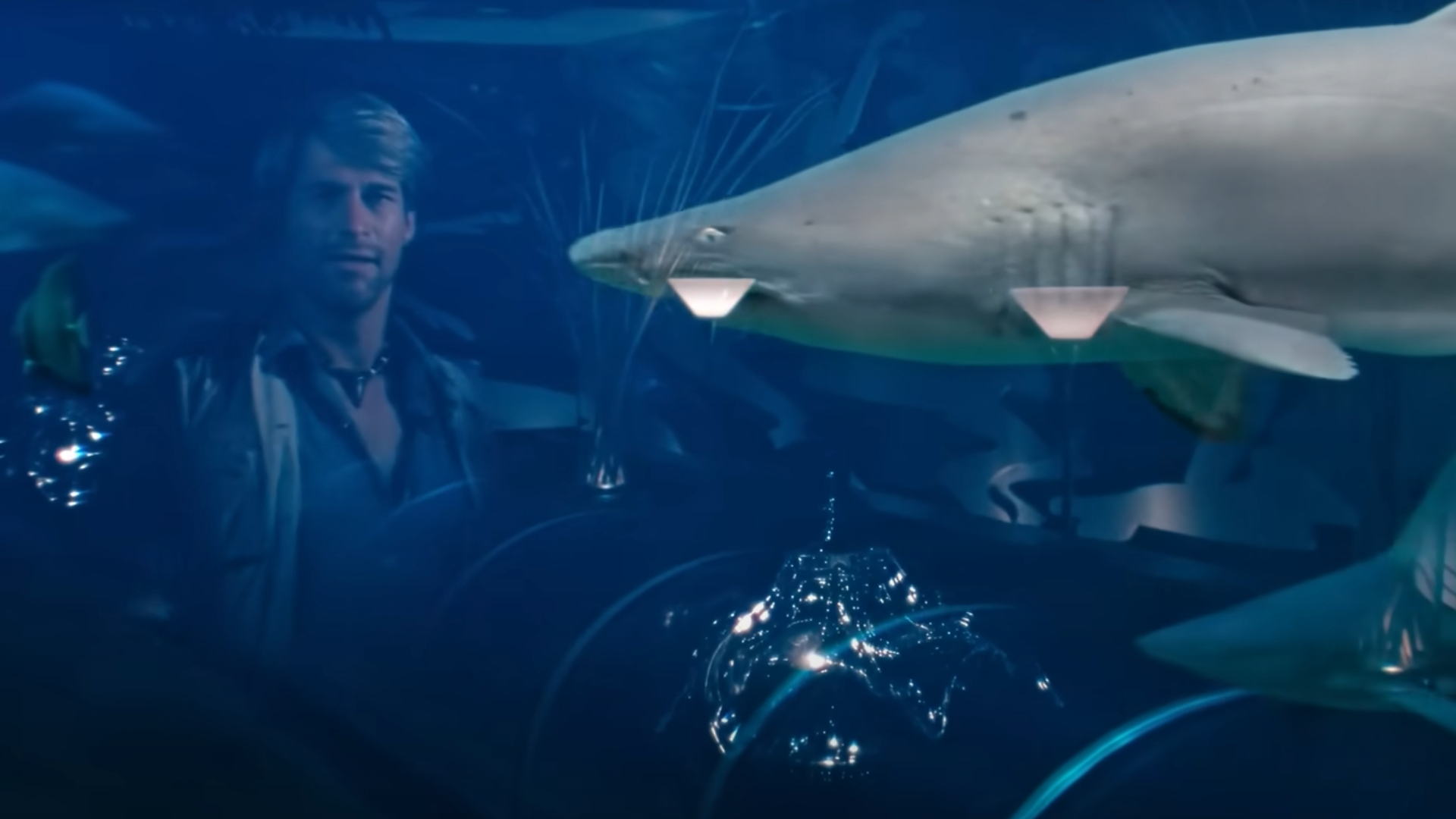 Simon MacCorkindale looking at a shark in the Jaws 3-D Shark Attack At The Opening Ceremony Extended Preview