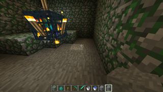 Mine the mossy cobblestone floor so that there is a space below the monster spawner.