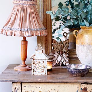 wooden table with lamp and plants pot