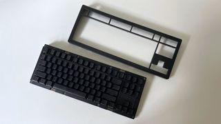 The Drop CSTM80 mechanical keyboard with the top case removed on a white table