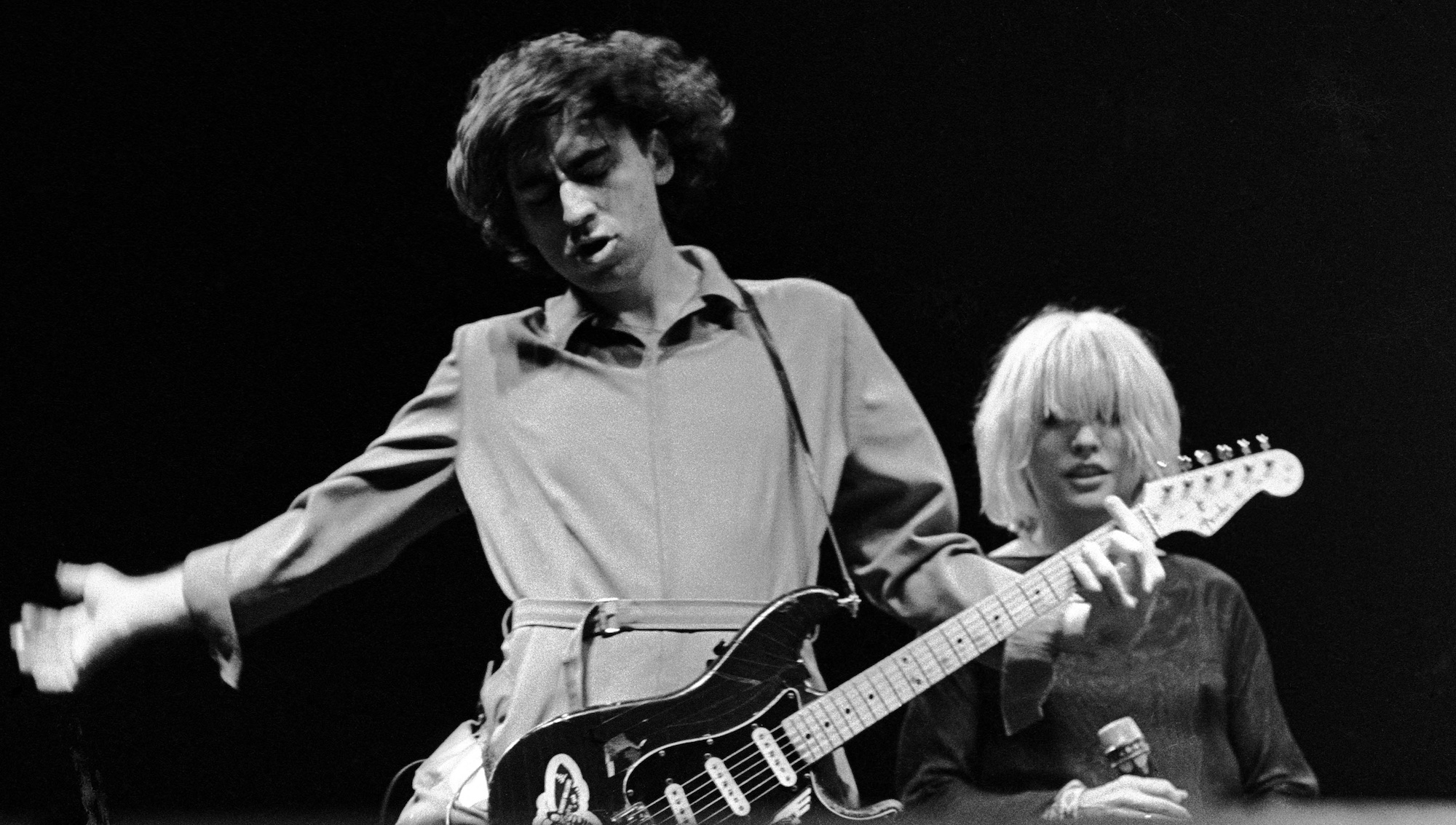 Chris Stein (foreground) and Debbie Harry (background) onstage with Blondie in London