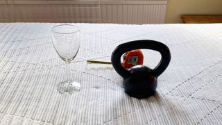 A wine glass, weight and tape measure on the Silentnight Lift Replenish Hybrid 2000 mattress