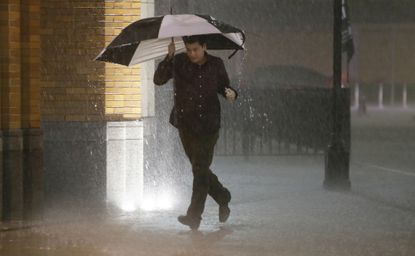 A man runs through downtown Dallas, which was under a tornado warning Saturday 