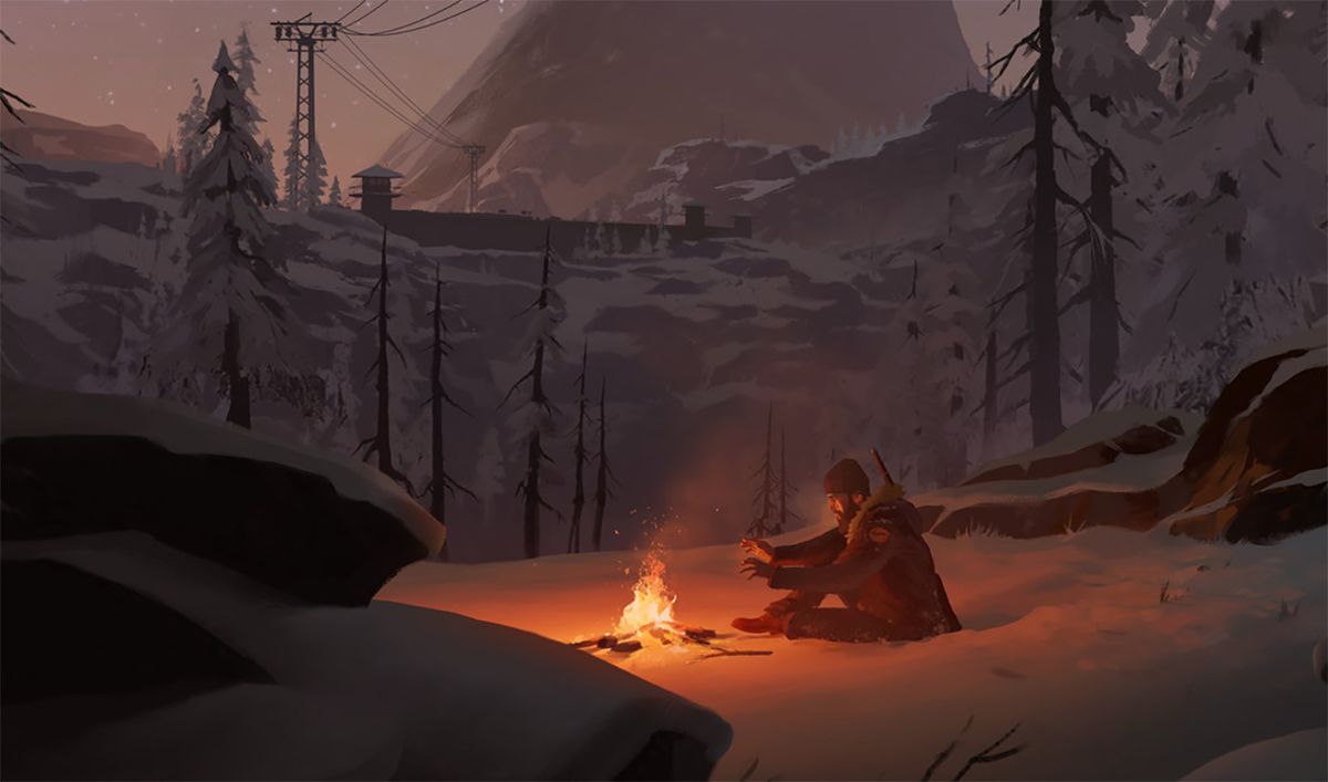 A man sitting by a campfire in winter. 