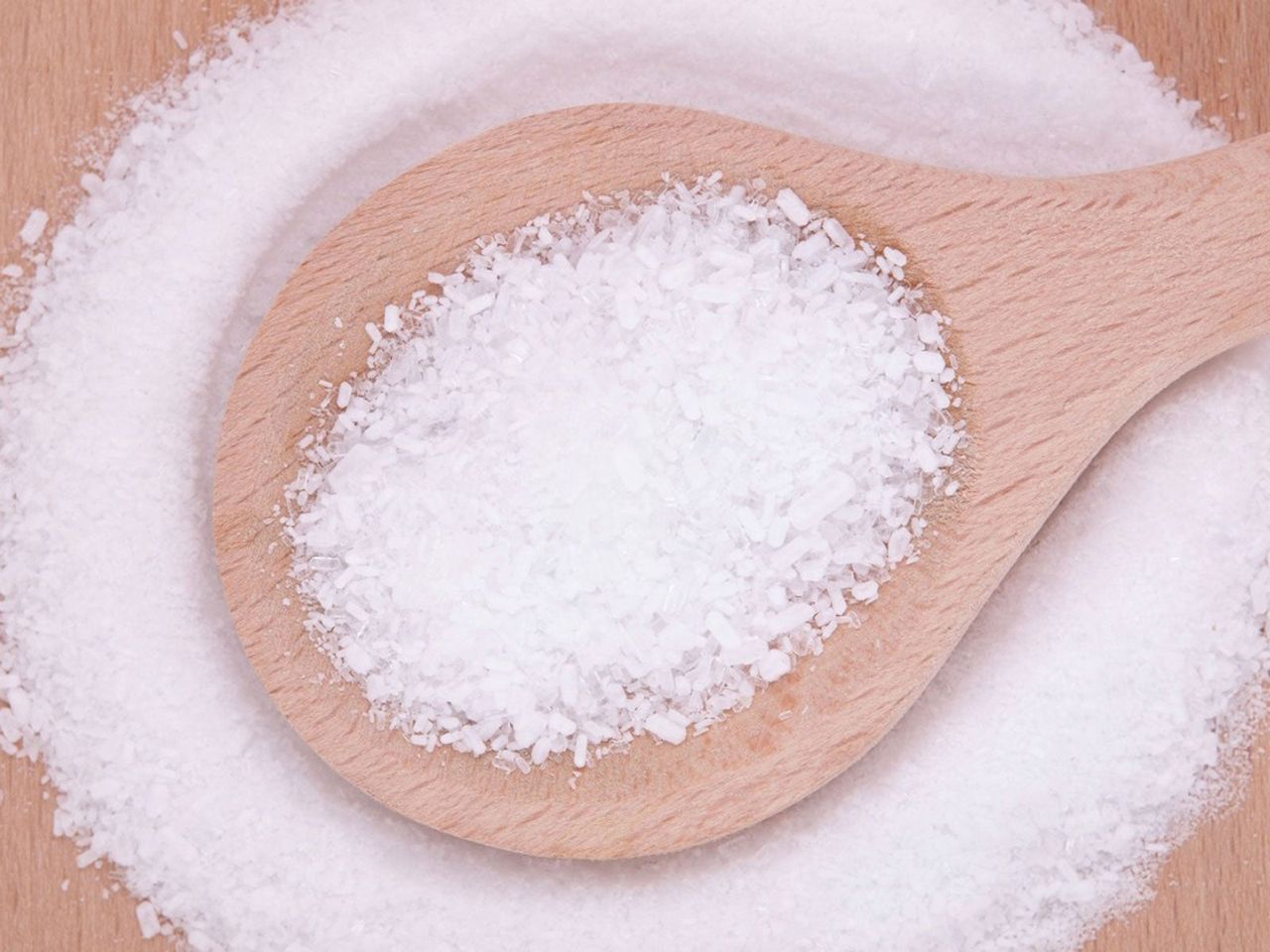 Salt Pile With Wooden Spoon Full Of Salt